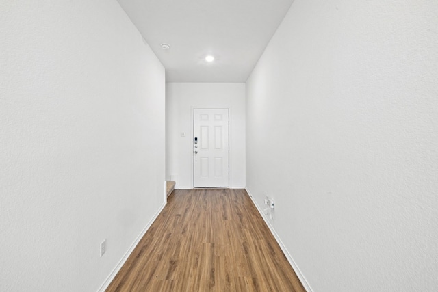 corridor with wood-type flooring