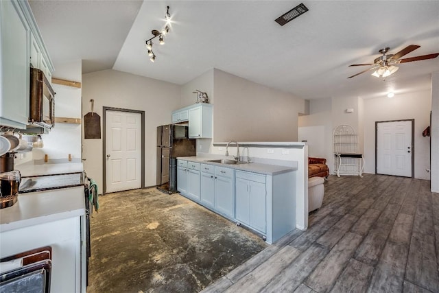 kitchen featuring lofted ceiling, sink, dark hardwood / wood-style floors, ceiling fan, and black appliances