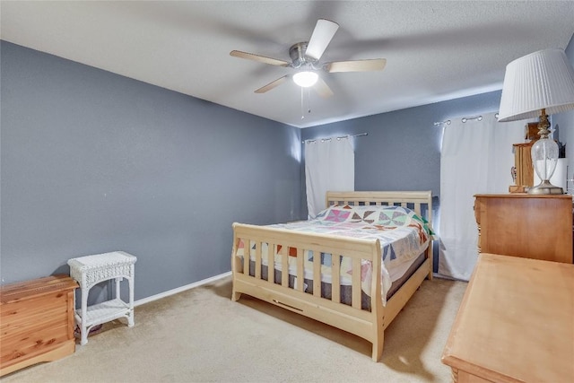 bedroom featuring light carpet and ceiling fan