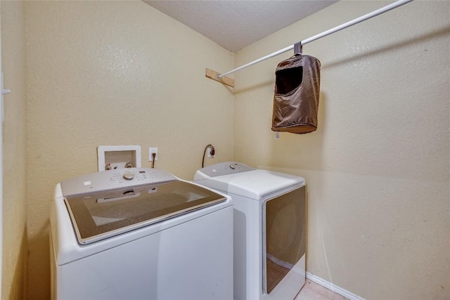 laundry room featuring separate washer and dryer and a textured ceiling