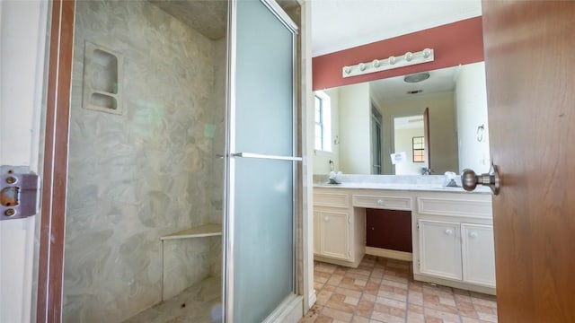 bathroom featuring a shower with door, vanity, and ornamental molding