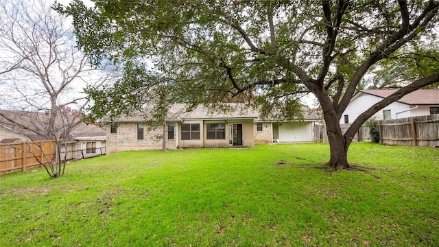 back of property with a lawn