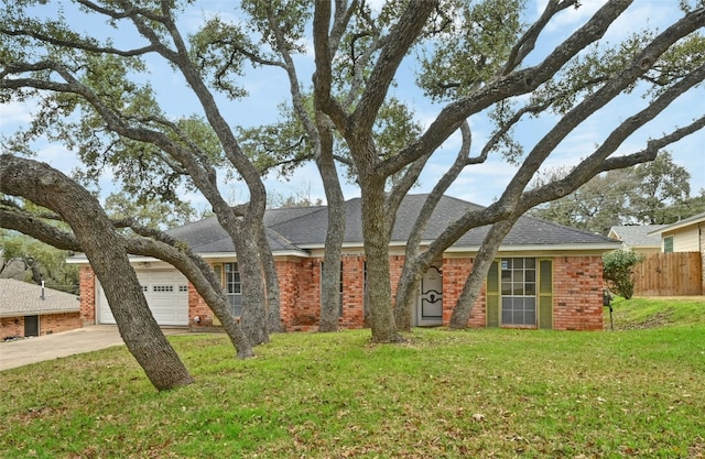 ranch-style house featuring a garage and a front lawn