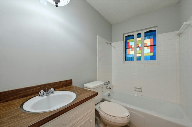 full bathroom featuring tiled shower / bath combo, vanity, a textured ceiling, and toilet