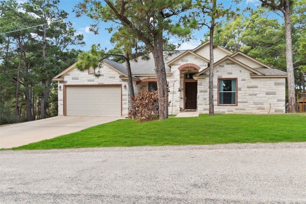 view of front of property with a garage and a front yard