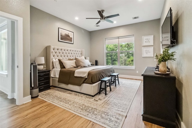 bedroom with light hardwood / wood-style flooring and ceiling fan