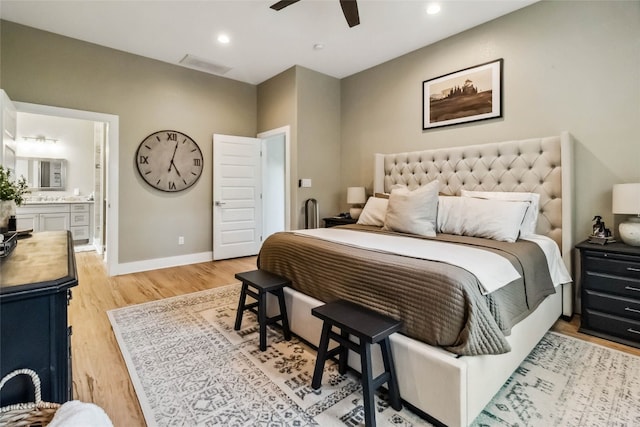 bedroom featuring connected bathroom, light hardwood / wood-style floors, and ceiling fan