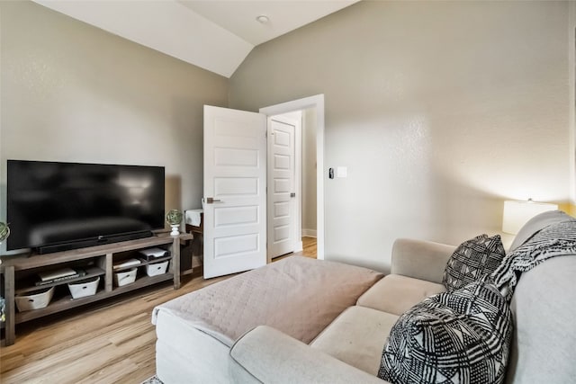 living room with lofted ceiling and light hardwood / wood-style floors