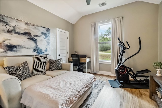 bedroom featuring ceiling fan, light hardwood / wood-style floors, and vaulted ceiling