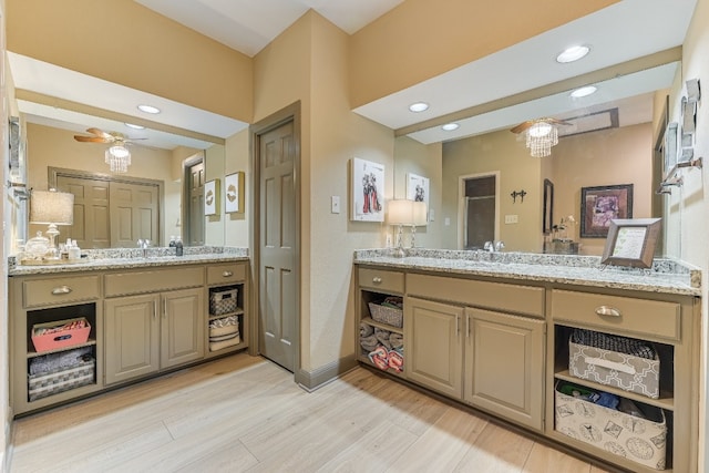 bathroom featuring wood-type flooring, vanity, and ceiling fan