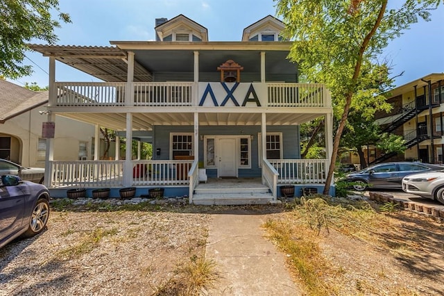 view of front of property featuring a porch and a balcony