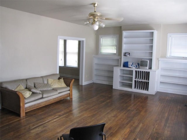 living room featuring ceiling fan, baseboards, and wood finished floors