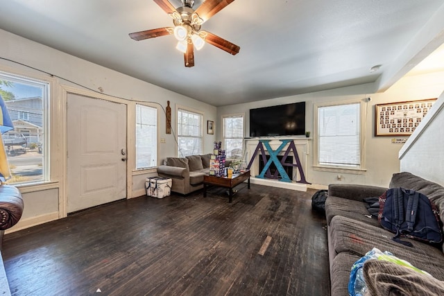 living room featuring ceiling fan, wood finished floors, baseboards, and a healthy amount of sunlight