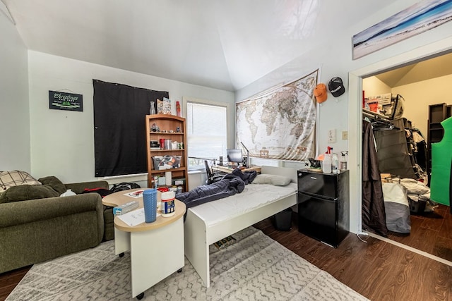 interior space with lofted ceiling and wood finished floors