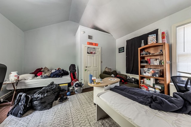 carpeted bedroom featuring lofted ceiling