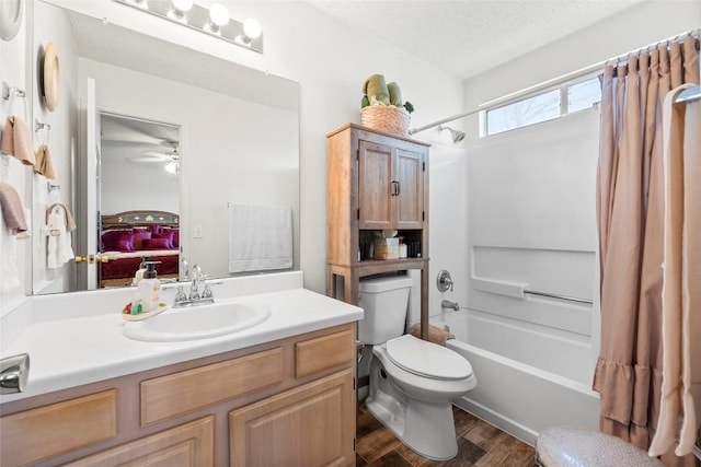 full bathroom featuring toilet, a textured ceiling, vanity, shower / bath combo with shower curtain, and hardwood / wood-style flooring