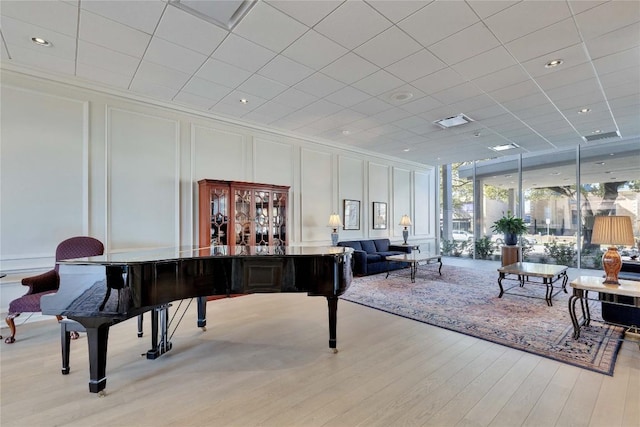 interior space with a wall of windows and light hardwood / wood-style floors