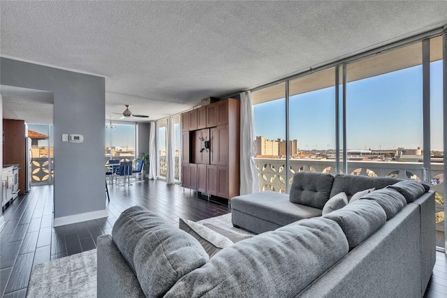 living room with expansive windows, dark wood-type flooring, and a textured ceiling