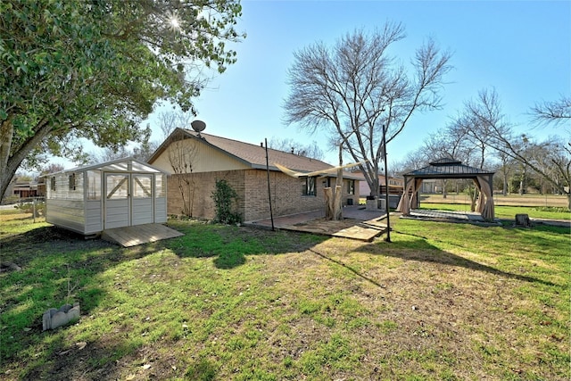 exterior space with a shed, a gazebo, and a lawn