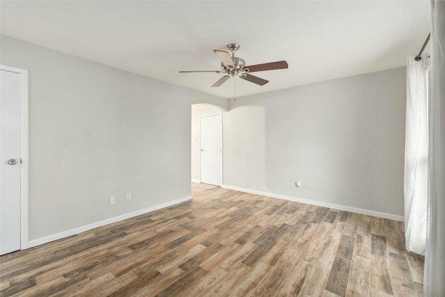 unfurnished room with ceiling fan and wood-type flooring