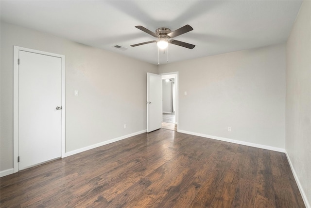 unfurnished room with dark hardwood / wood-style flooring and ceiling fan