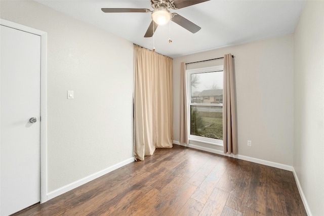 empty room with dark wood-type flooring and ceiling fan