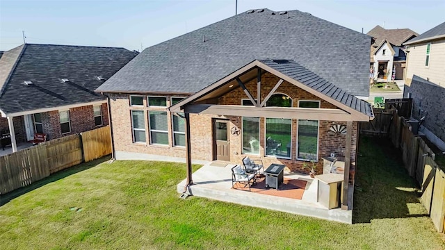 rear view of property with a patio and a yard