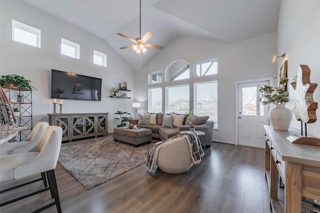 living room featuring ceiling fan, dark hardwood / wood-style floors, and high vaulted ceiling