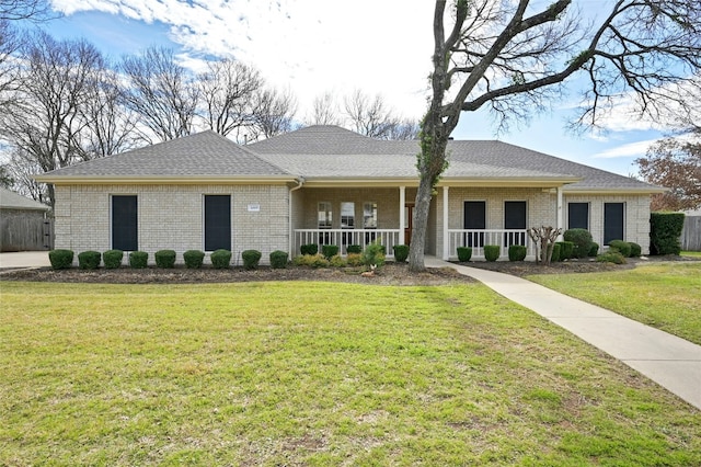 ranch-style home with covered porch and a front lawn