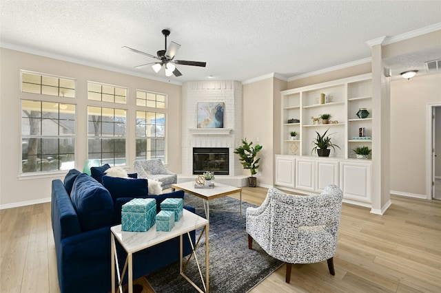 living room featuring crown molding, a textured ceiling, and light wood-type flooring