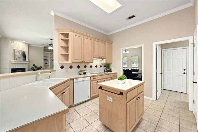 kitchen featuring dishwasher, a center island, sink, and light brown cabinets