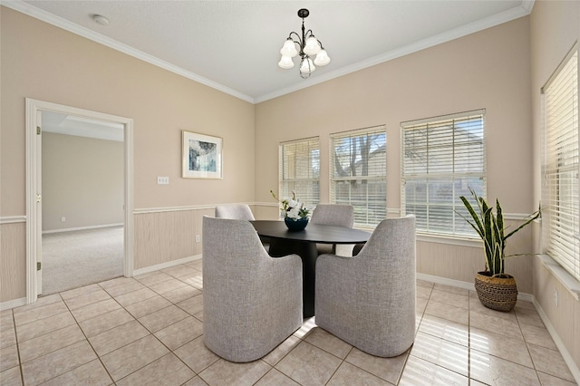 dining space featuring crown molding, light tile patterned flooring, and an inviting chandelier