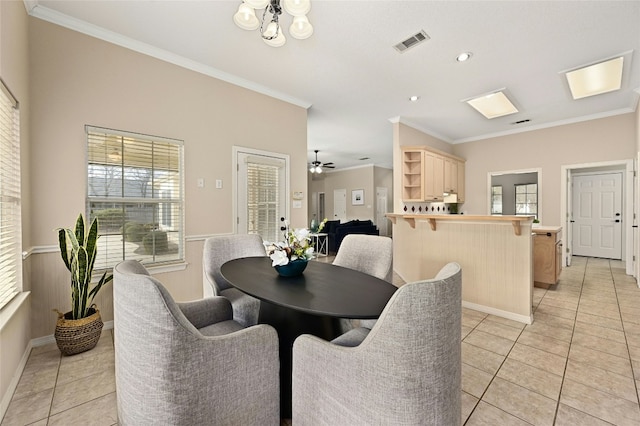 tiled dining space featuring ornamental molding