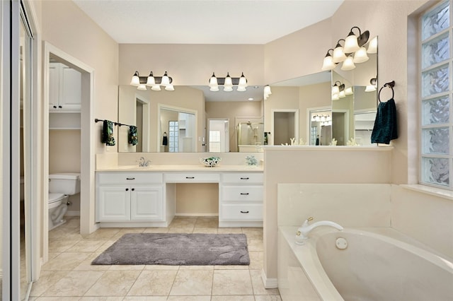 bathroom with vanity, a washtub, tile patterned floors, and toilet