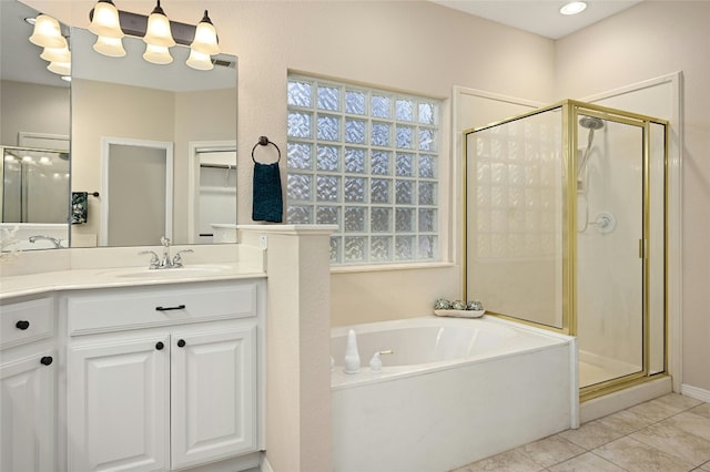 bathroom featuring vanity, tile patterned flooring, and separate shower and tub