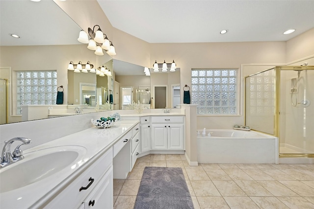 bathroom with independent shower and bath, vanity, a wealth of natural light, and tile patterned floors