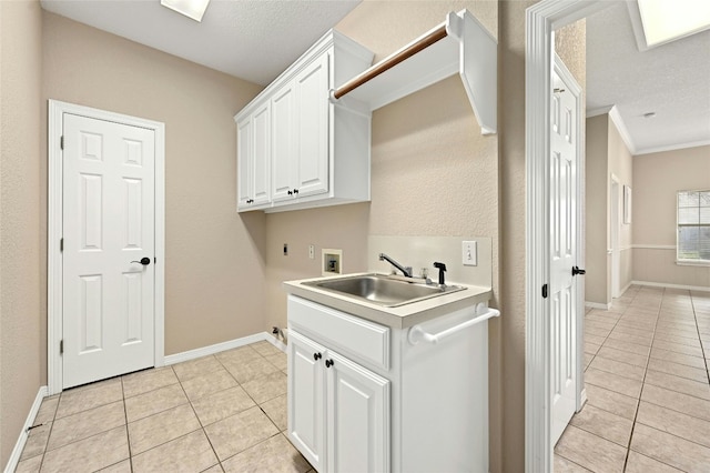 laundry area featuring sink, cabinets, washer hookup, light tile patterned floors, and electric dryer hookup