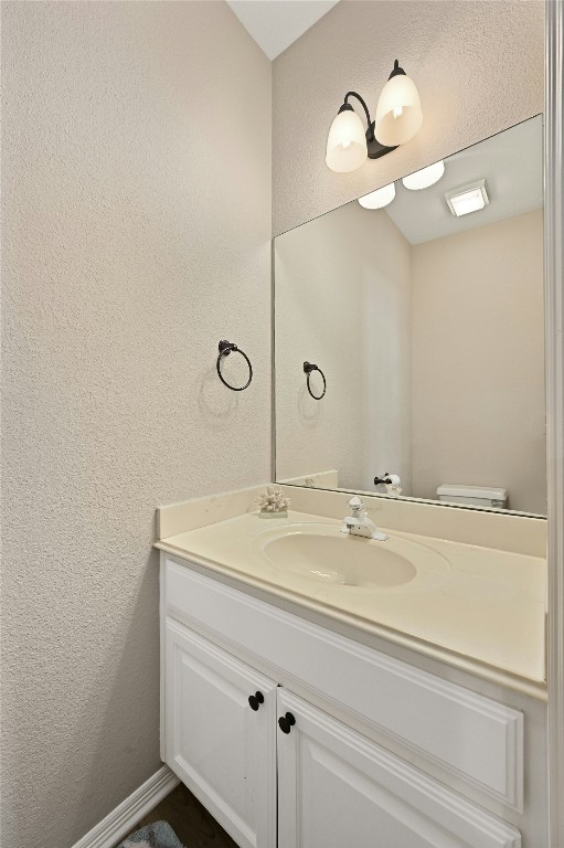 bathroom with vanity and toilet