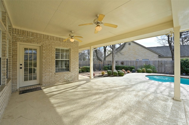 view of patio with a fenced in pool and ceiling fan