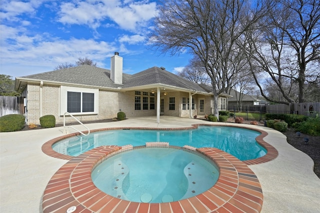 view of swimming pool featuring an in ground hot tub and a patio