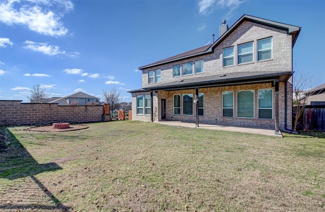 back of property featuring a patio and a yard