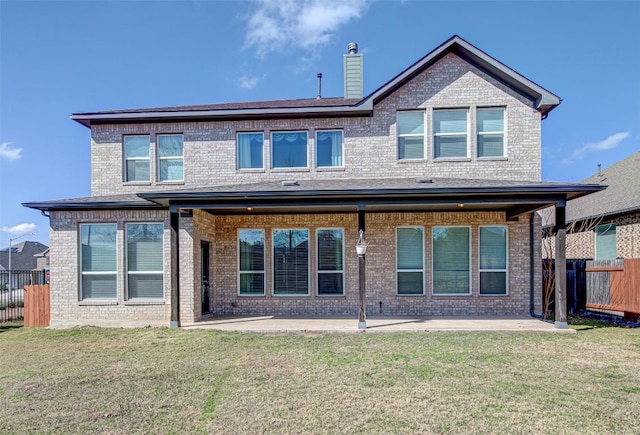 rear view of house with a patio area and a lawn