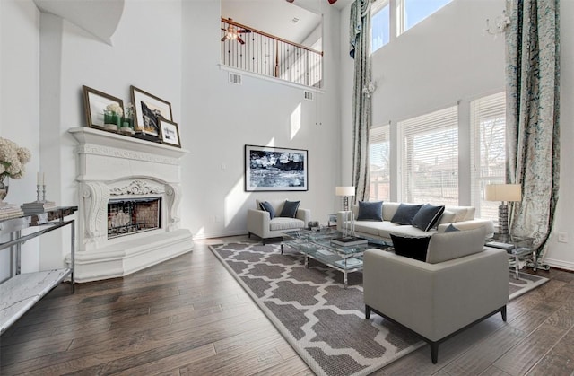 living room featuring dark hardwood / wood-style floors and a high ceiling