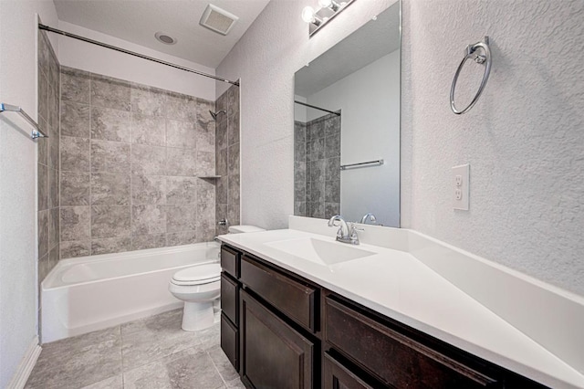 full bathroom with vanity, tiled shower / bath combo, and toilet