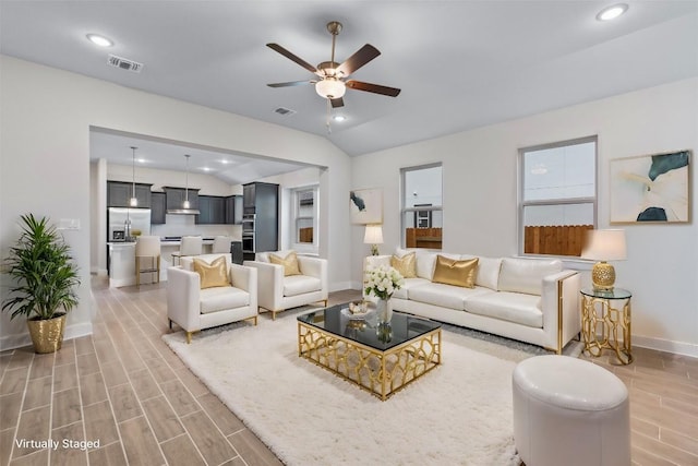 living room featuring ceiling fan and vaulted ceiling