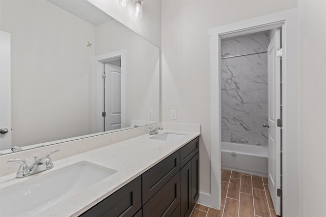 bathroom featuring vanity and tiled shower / bath combo