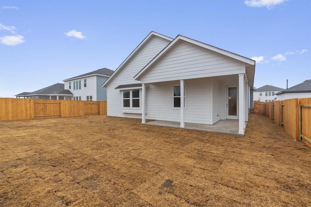 rear view of house featuring a patio area and a fenced backyard