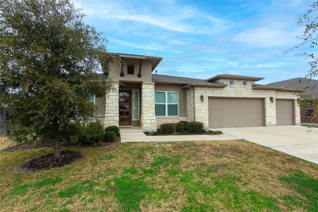 prairie-style home with a garage and a front lawn