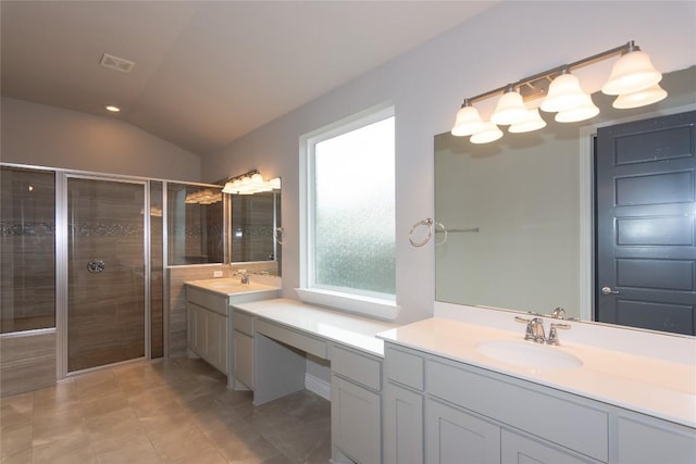 bathroom featuring tile patterned flooring, vanity, an enclosed shower, and vaulted ceiling