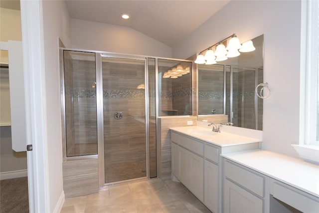 bathroom with vanity, vaulted ceiling, and a shower with shower door